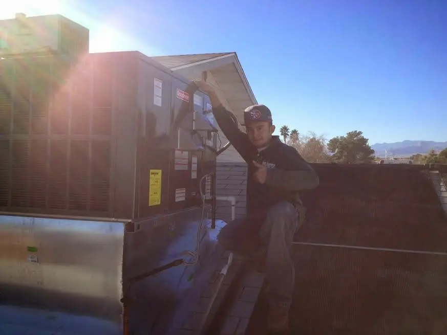 HVAC technician performing HVAC Inspection on a rooftop unit in Wonder Lake